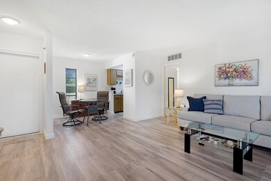 Living area featuring light wood-style floors and baseboards