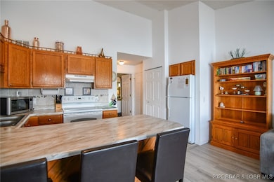 Cabinets above fridge for extra storage. Room for