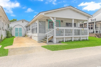 View of front facade with a storage shed, covered 