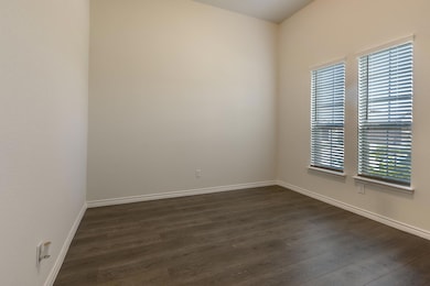 Unfurnished room featuring dark hardwood / wood-style floors