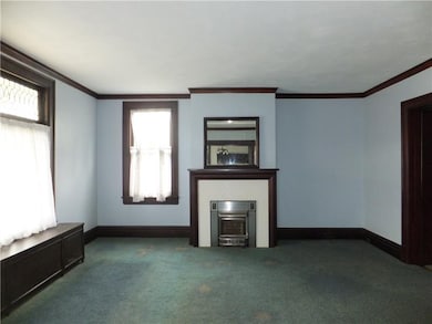 Large living room with decorative fireplace.