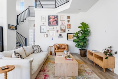Living room with stairs, wood finished floors, a 