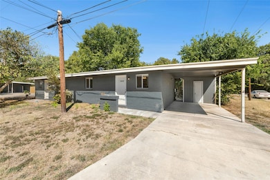 View of front facade featuring a carport and driveway