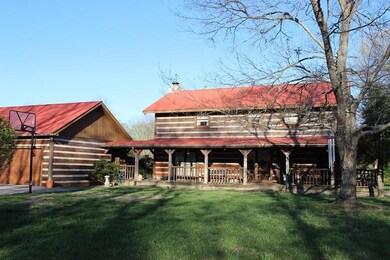 This Is A View Of The Rear Of The Home - It Has A Wrap-A-Round Porch And An Over-sized 2-Car Detached Garage