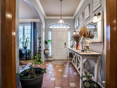Tiled entrance foyer with crown molding