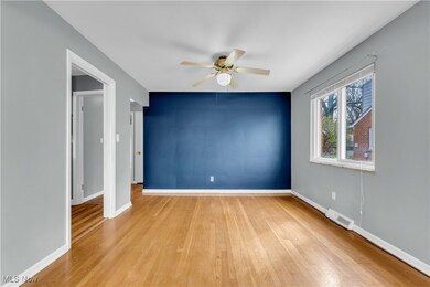 Spare room with light wood finished floors, ceiling fan, baseboards, and visible vents