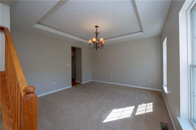 Formal dining room with tray ceiling...