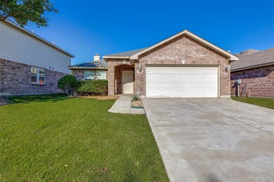 Ranch-style house featuring a front lawn and a gar