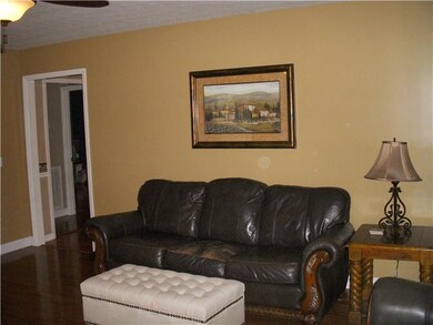 Another view of the large living room and hardwood flooring