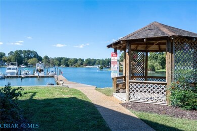 Dock area featuring a lawn, a gazebo, and a water view