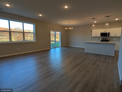 Large family room filled with luminous natural light, seamlessly connecting to a spacious open floorplan for easy living and entertaining.