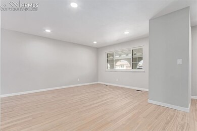 Unfurnished room with light wood-style flooring, baseboards, and recessed lighting