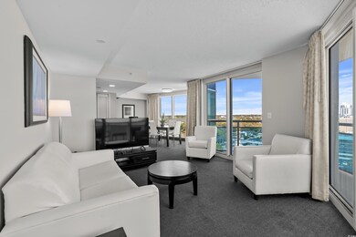 Living room featuring dark carpet, a textured ceil