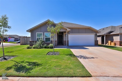 View of front of house with a front yard and a gar
