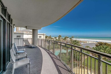 Balcony featuring a water view and a view of the b