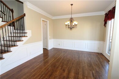 Beautiful dining room opens to the foyer.  Notice the wainscoting and crown moulding. 