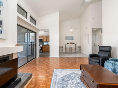 Living room with baseboards, high vaulted ceiling