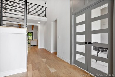Beautiful modern entry with wide-planked, white oa