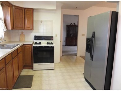 Kitchen has been updated with new cabinets and cer