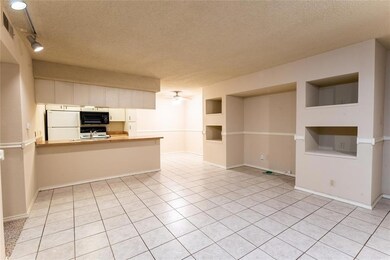 Unfurnished living room featuring a textured ceiling, built in shelves, light tile patterned flooring, a ceiling fan, and rail lighting