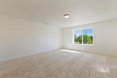 Carpeted empty room with baseboards and a textured ceiling