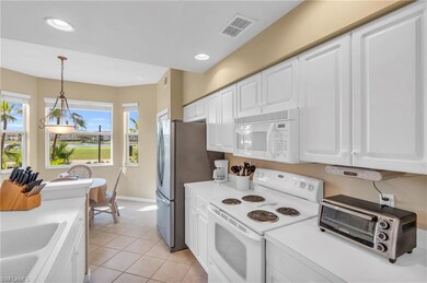 Kitchen featuring white cabinetry, white appliance