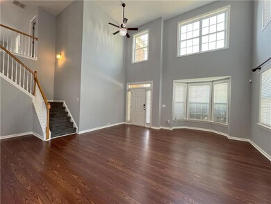Entryway featuring baseboards, visible vents, wood