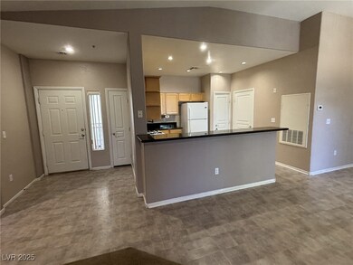 Kitchen with freestanding refrigerator, dark floor