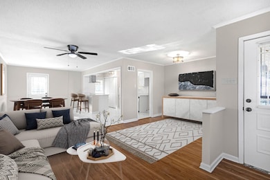 Living room with hardwood / wood-style floors, a t