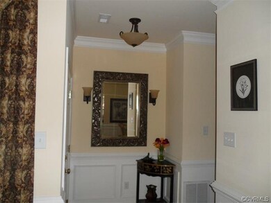 Foyer with hardwood floors, upgraded lighting, ext