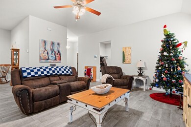 Living area with light wood-type flooring and a ceiling fan