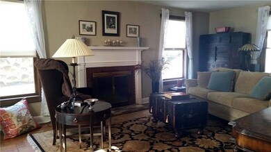 Spacious living room has windows on three sides. Light and bright! Wood burning fireplace has not been used. Buyer must check.