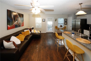 Living room with sink, dark wood-type flooring, a 