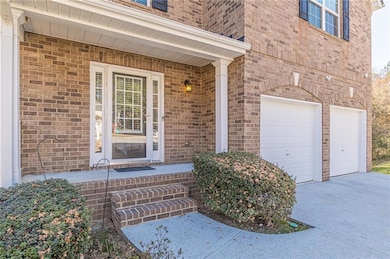 View of exterior entry with a garage