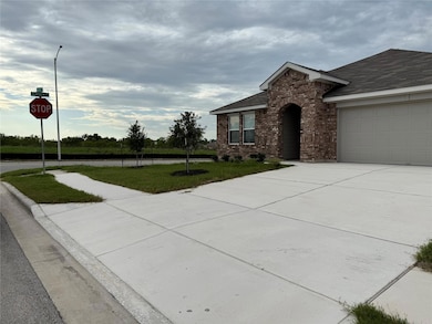 View of front of house with brick siding, drivewa