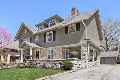 Beautiful covered front porch and stone pillars ar