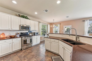 Kitchen featuring appliances with stainless steel