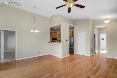 Living room featuring high vaulted ceiling, light 