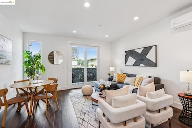 Living room featuring dark wood-style flooring, recessed lighting, and a wall unit AC