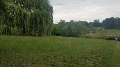 Rolling 5 acres with a shared pond.