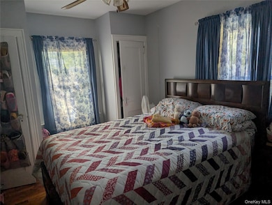 Bedroom featuring dark wood-style floors and a ceiling fan