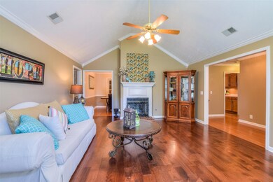 Living room with vaulted ceiling and gas fire place - beautiful wood floors!
