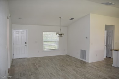 Unfurnished dining area with a chandelier and baseboards
