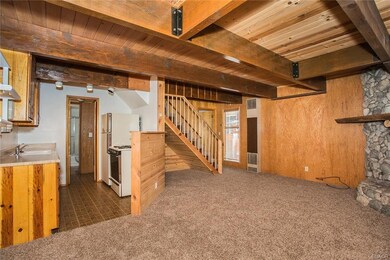 Spacious living room open to kitchen with rock fir