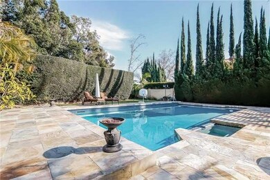 Pool and Jacuzzi surrounded with elegant mature tr