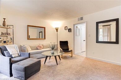 Living room with hallway that includes main floor laundry with half bath