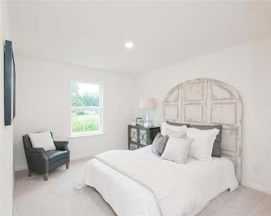 Carpeted bedroom featuring baseboards and recessed lighting