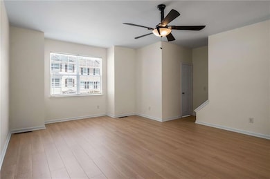 Empty room with light wood-type flooring, baseboar