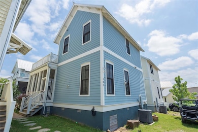 View of property exterior with a balcony, a lawn, 