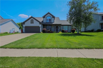 Front of property featuring a garage and a front lawn
